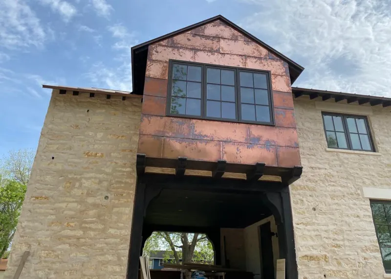 Copper metal panel facade on a stone building for Metal Roof Coating in Ellsworth